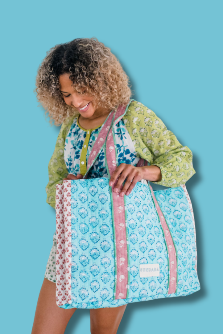 Woman carrying the Sundara quilted tote bag on her shoulder – a spacious and stylish carryall perfect for everyday use, showcasing its luxurious design