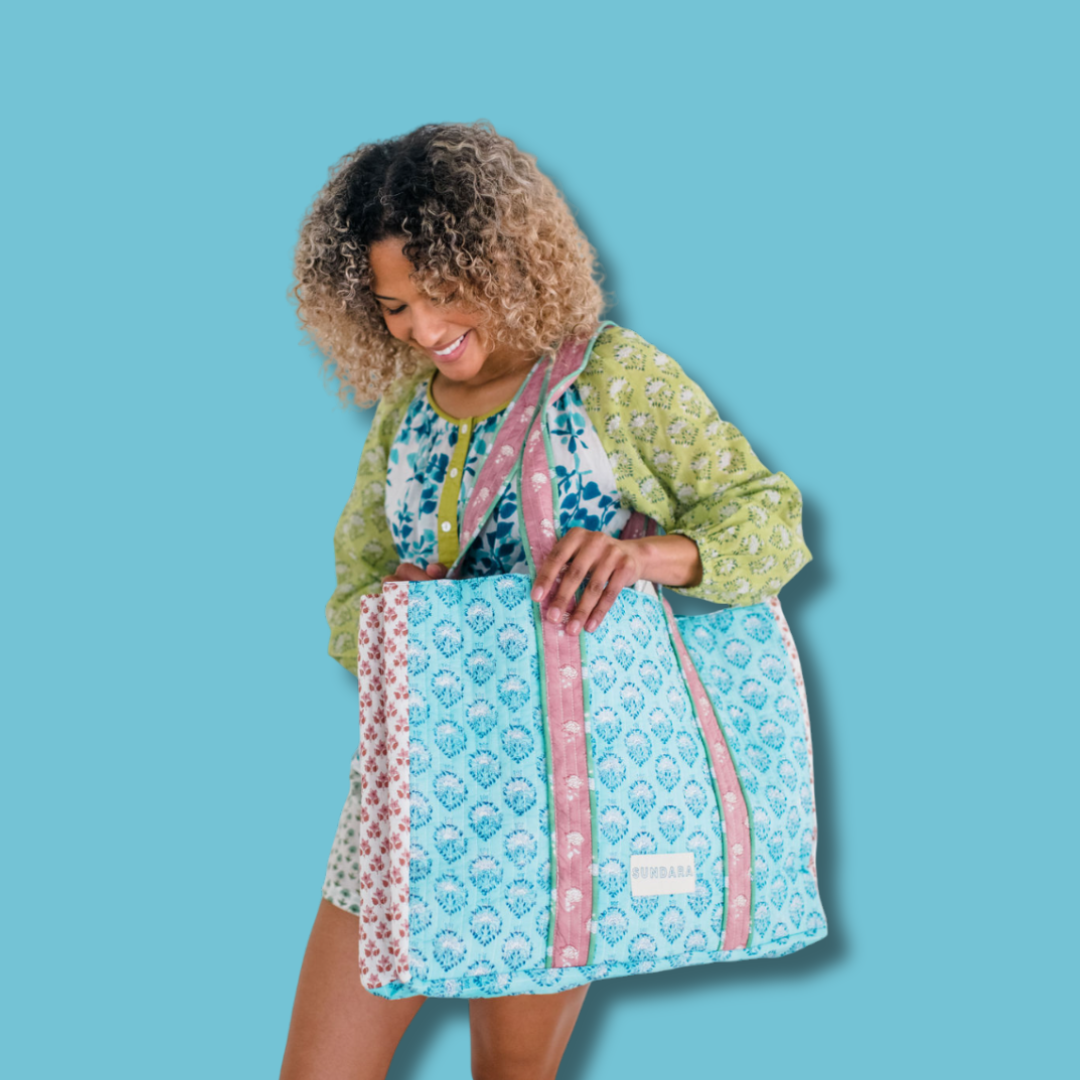 Woman carrying the Sundara quilted tote bag on her shoulder – a spacious and stylish carryall perfect for everyday use, showcasing its luxurious design