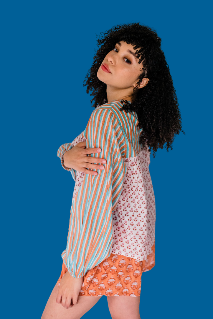 Woman wear the Lauren Top by Sundara – a soft cotton pajama top with a button-front design, featuring delicate hand-block prints for effortless comfort.
