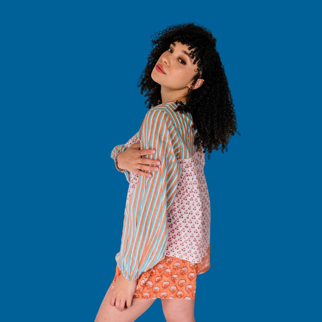 Woman wear the Lauren Top by Sundara – a soft cotton pajama top with a button-front design, featuring delicate hand-block prints for effortless comfort.