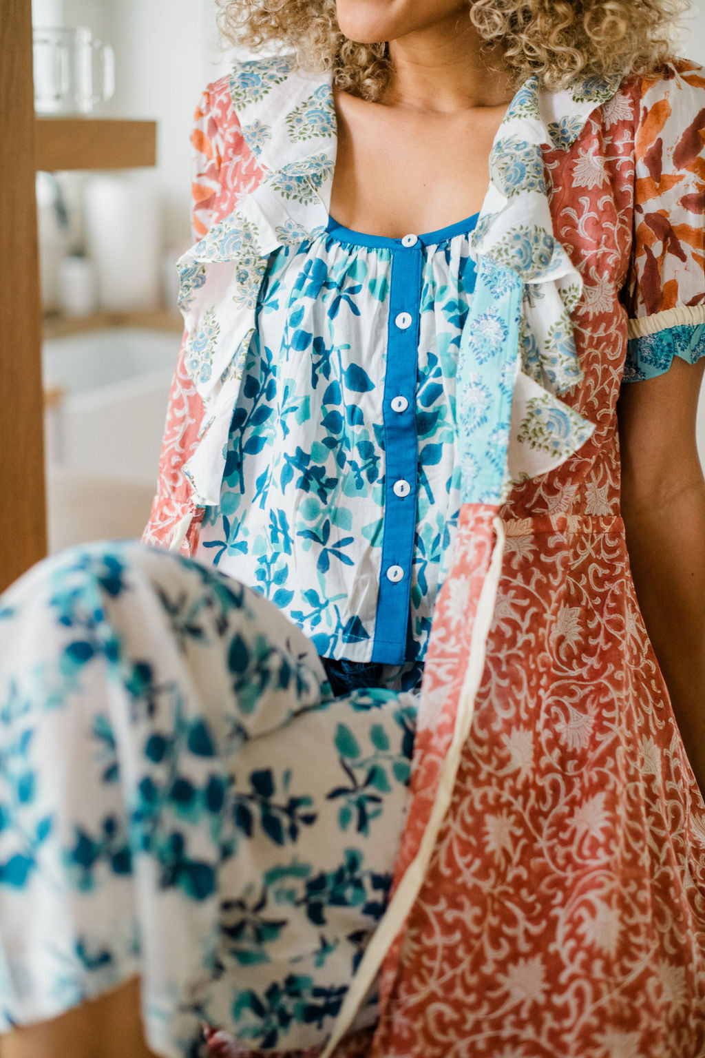 Woman wearing the Livi Pant, Ryan Top, and Jeanne Robe by Sundara – a cozy, hand-block printed cotton loungewear set, offering effortless comfort and elegant style for relaxing at home.