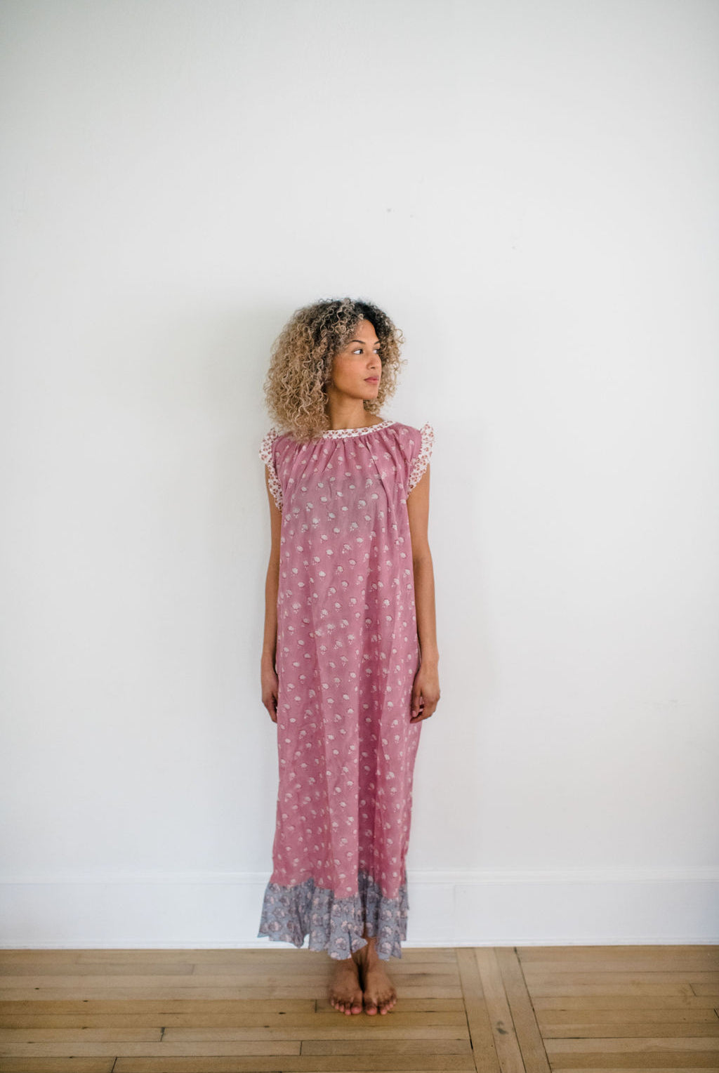 Woman in the Mae Nightgown by Sundara – soft cotton sleepwear with hand-block prints, blending comfort and casual elegance.