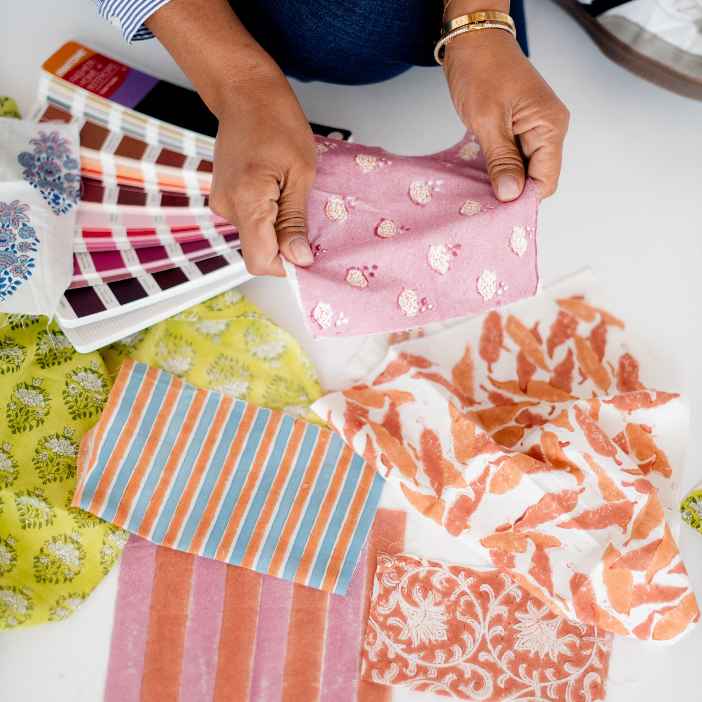 Erika, founder of Sundara, reviewing hand-block printed fabric swatches – thoughtfully designing loungewear that blends artistry, comfort, and sustainability