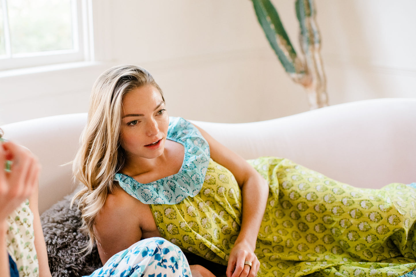 A woman wearing the Joce Nightgown by Sundara – a lightweight cotton nightgown with elegant hand-block prints and a flowy, feminine silhouette for restful nights.