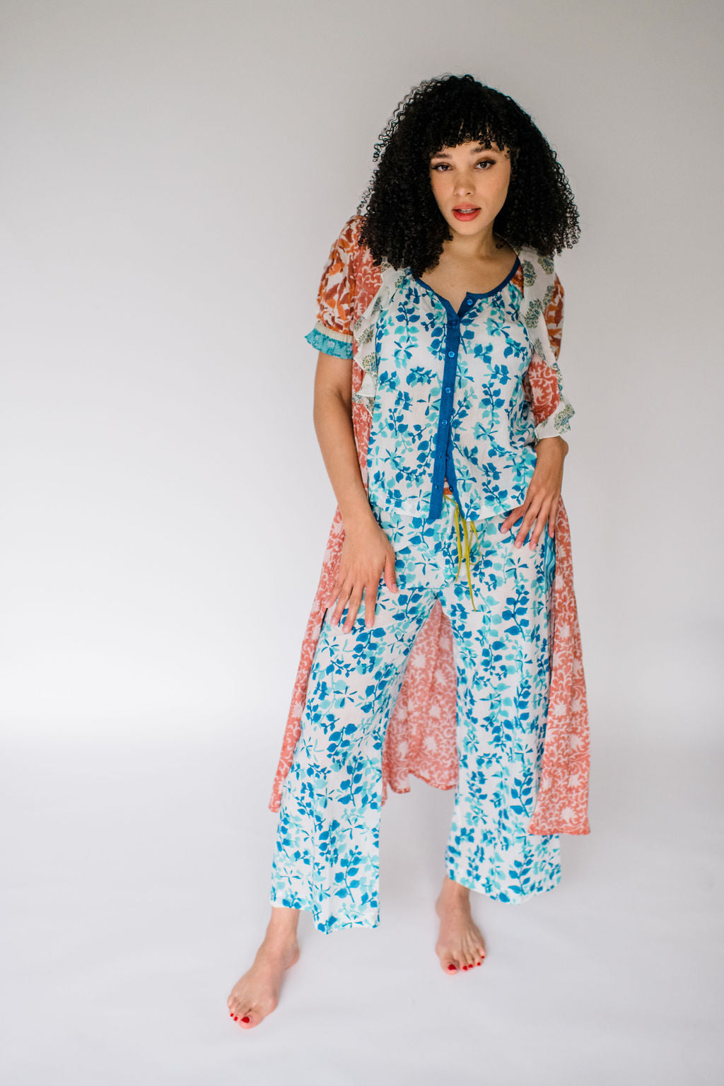 Woman wearing the Jeanne robe, the Ryan top and the Livi pant featuring an airy silhouette and delicate hand-printed detail for effortless comfort