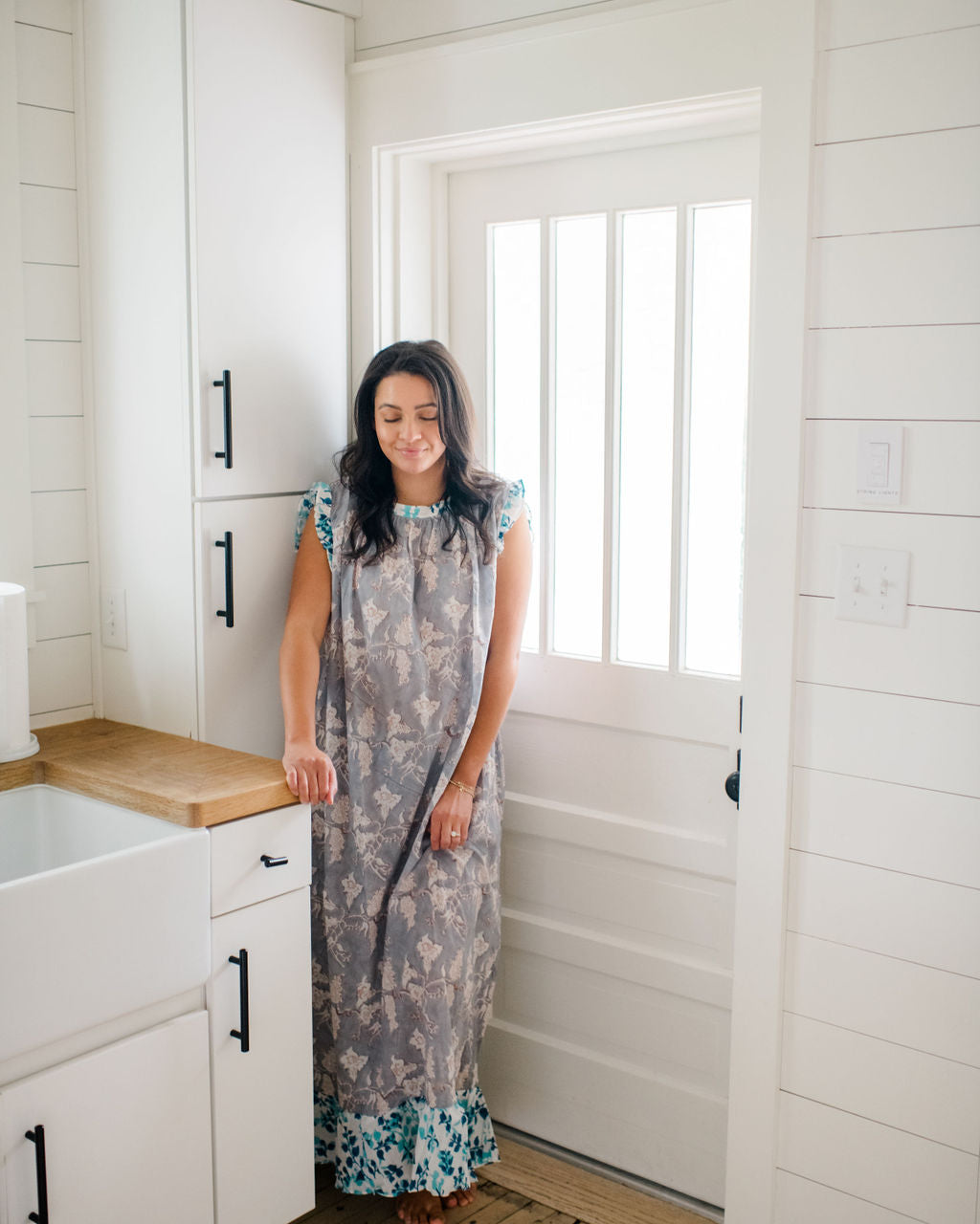 Woman standing in a kitchen wearing the Mae Nightgown by Sundara – a flowy, hand-block printed cotton nightgown perfect for slow mornings and everyday comfort