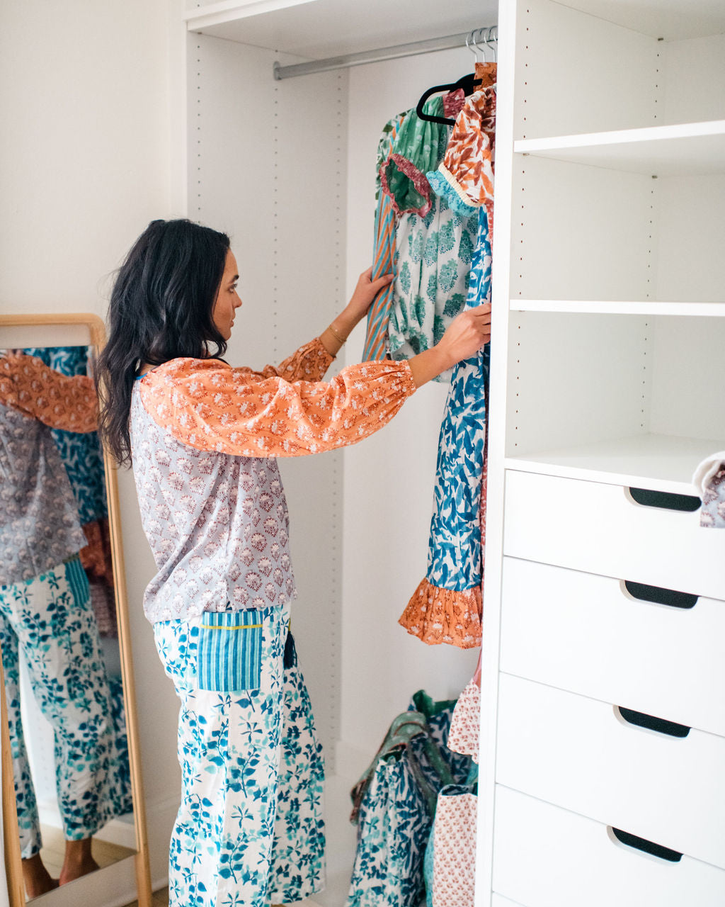 Model hanging Sundara block-printed pajamas in a closet – showcasing soft cotton sleepwear and intentional, slow-living style