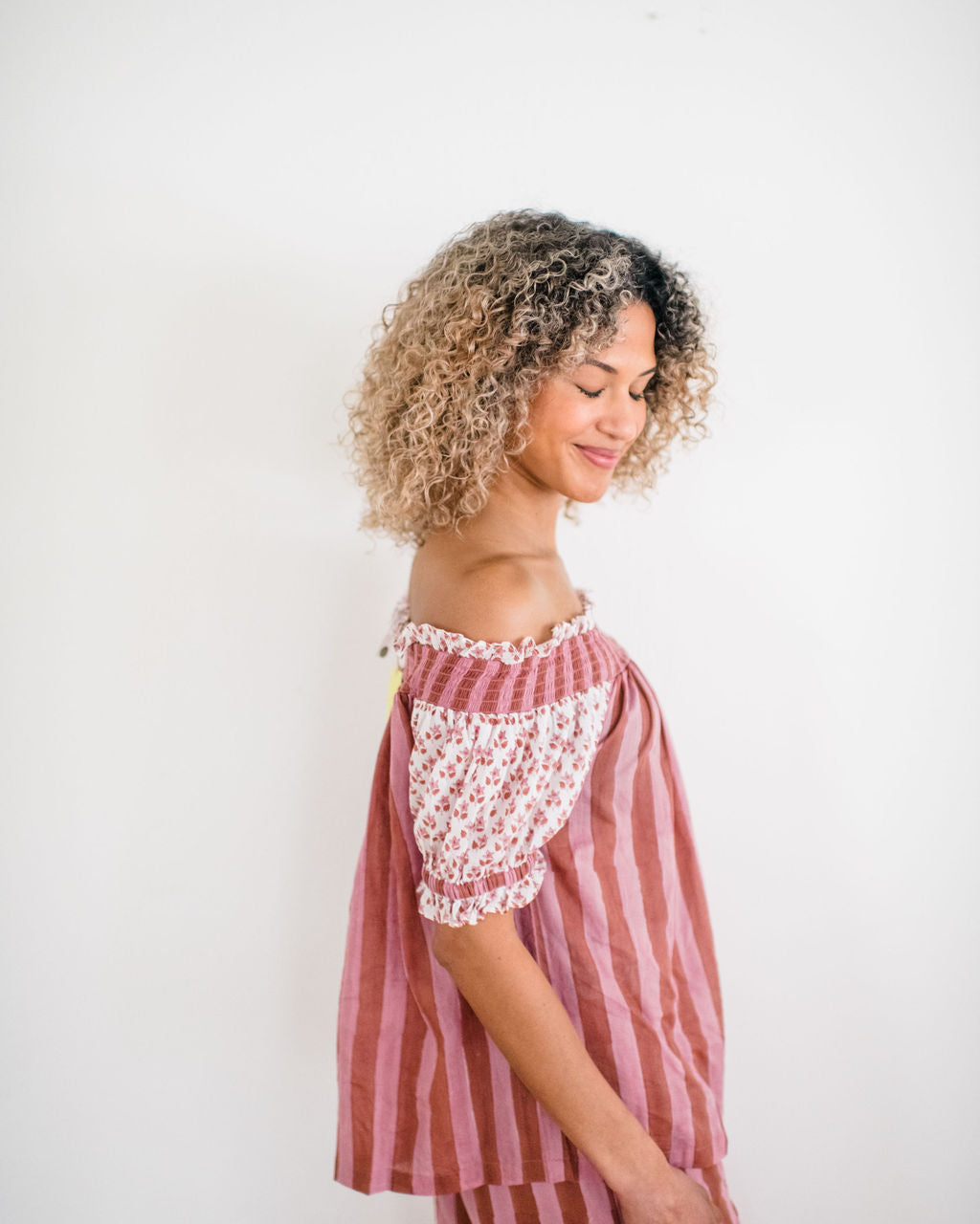 Woman wearing The Winnie Top by Sundara – a relaxed cotton pajama top with off-the-shoulder styling, featuring delicate hand-block prints for a laid-back, stylish look.