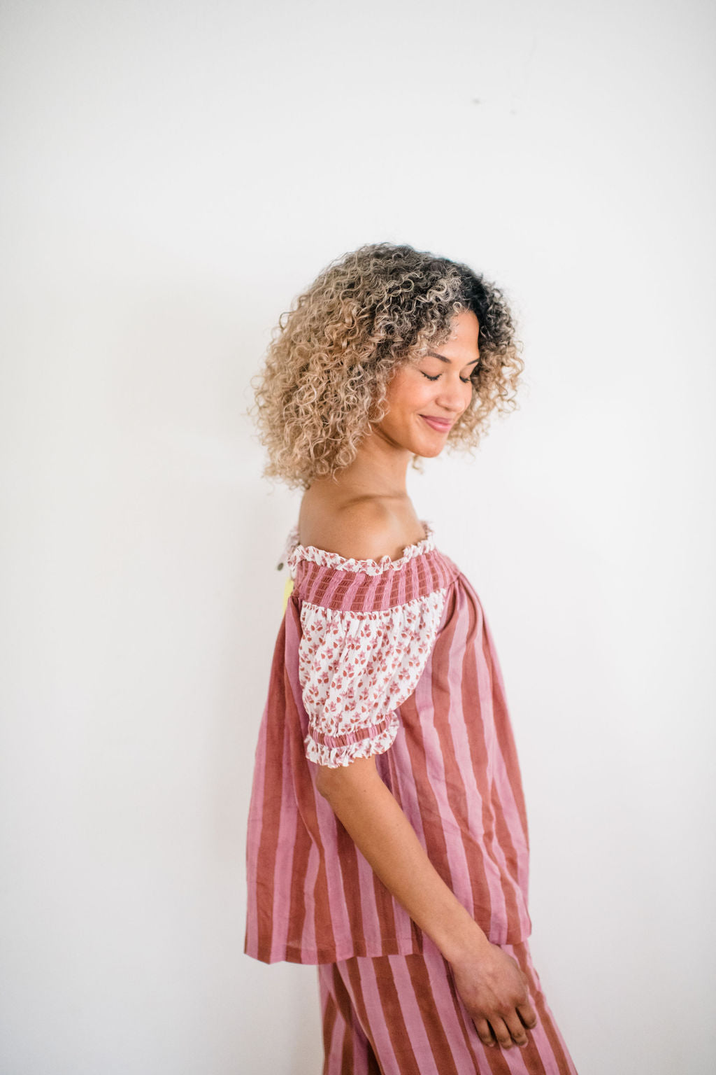 Woman wearing The Winnie Top by Sundara – a relaxed cotton pajama top with off-the-shoulder styling, featuring delicate hand-block prints for a laid-back, stylish look.
