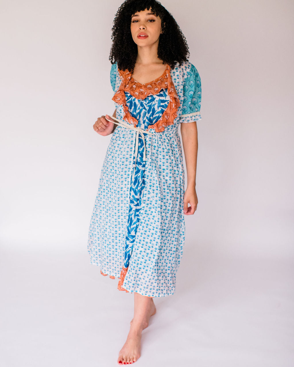 Woman wearing the Jeanne robe, featuring an airy silhouette and delicate hand-printed detail for effortless comfort