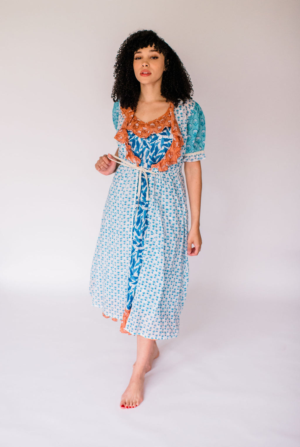 Woman wearing the Jeanne robe, featuring an airy silhouette and delicate hand-printed detail for effortless comfort