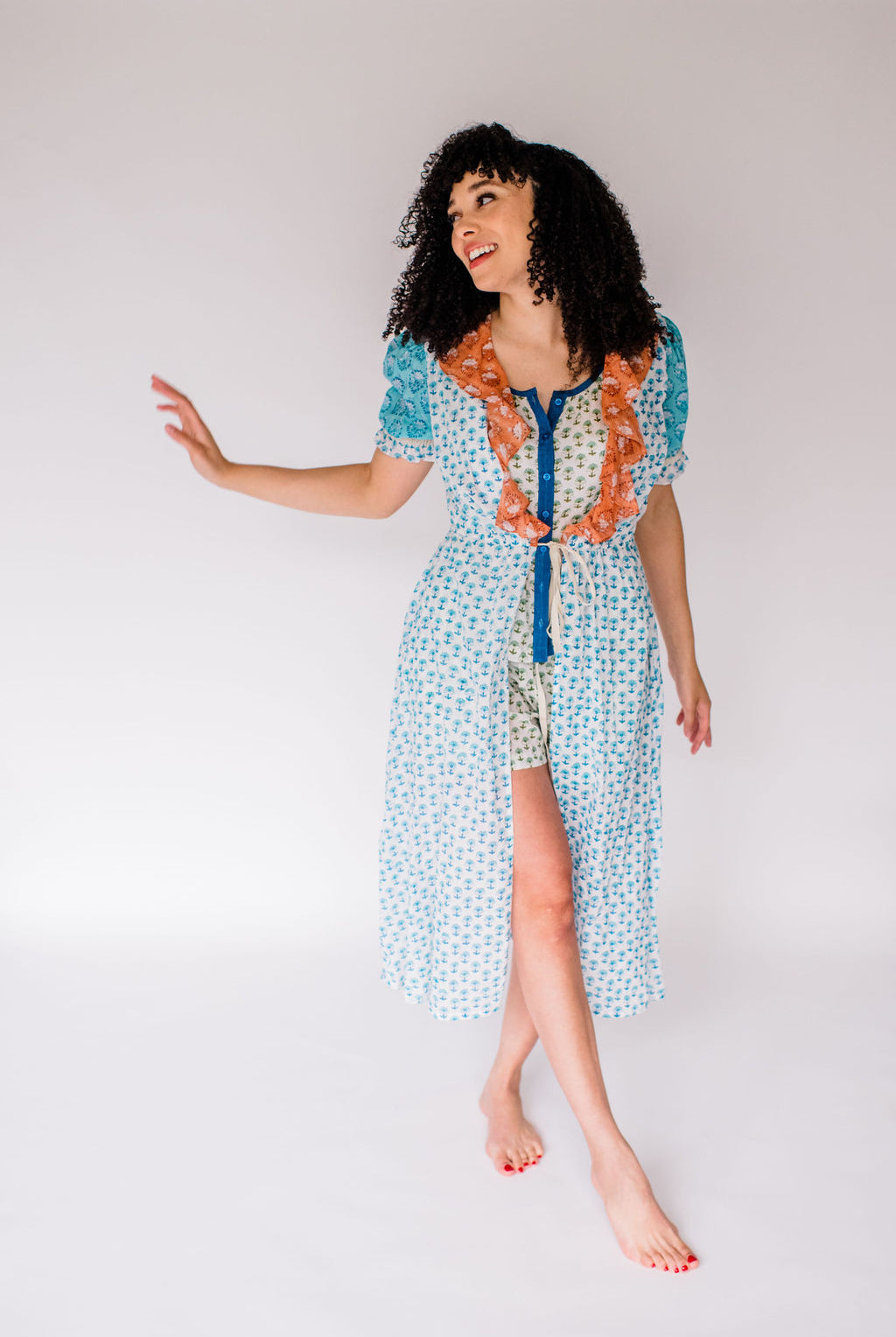 Woman wearing the Jeanne robe, featuring an airy silhouette and delicate hand-printed detail for effortless comfort