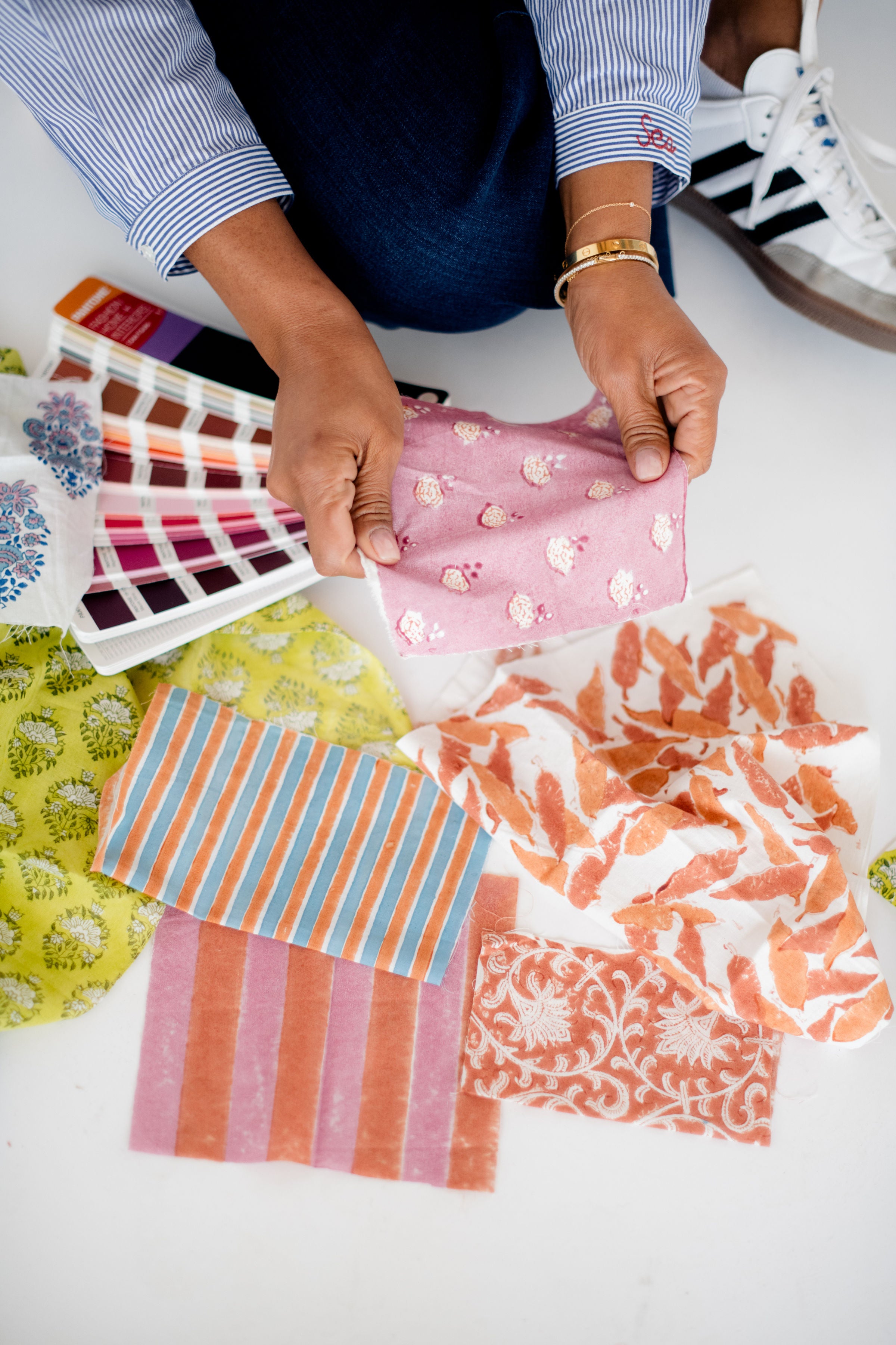 Erika, founder of Sundara, reviewing hand-block printed fabric swatches – thoughtfully designing loungewear that blends artistry, comfort, and sustainability