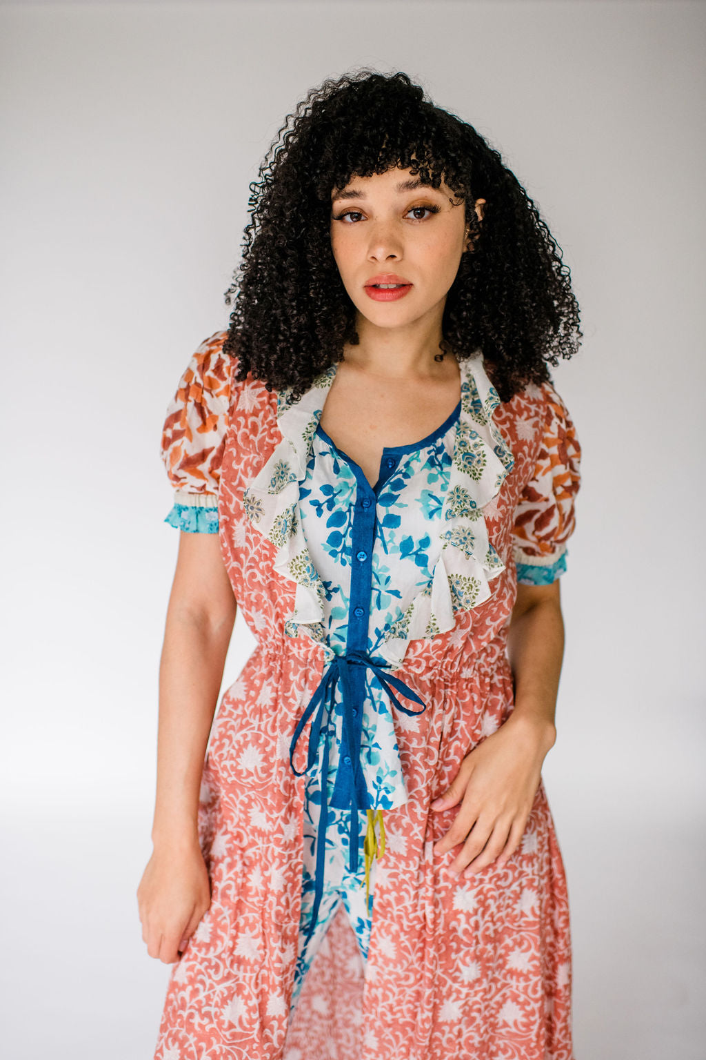 Woman wearing the Jeanne Robe by Sundara – a lightweight cotton robe with artisanal block prints and a relaxed belted silhouette, perfect for layering