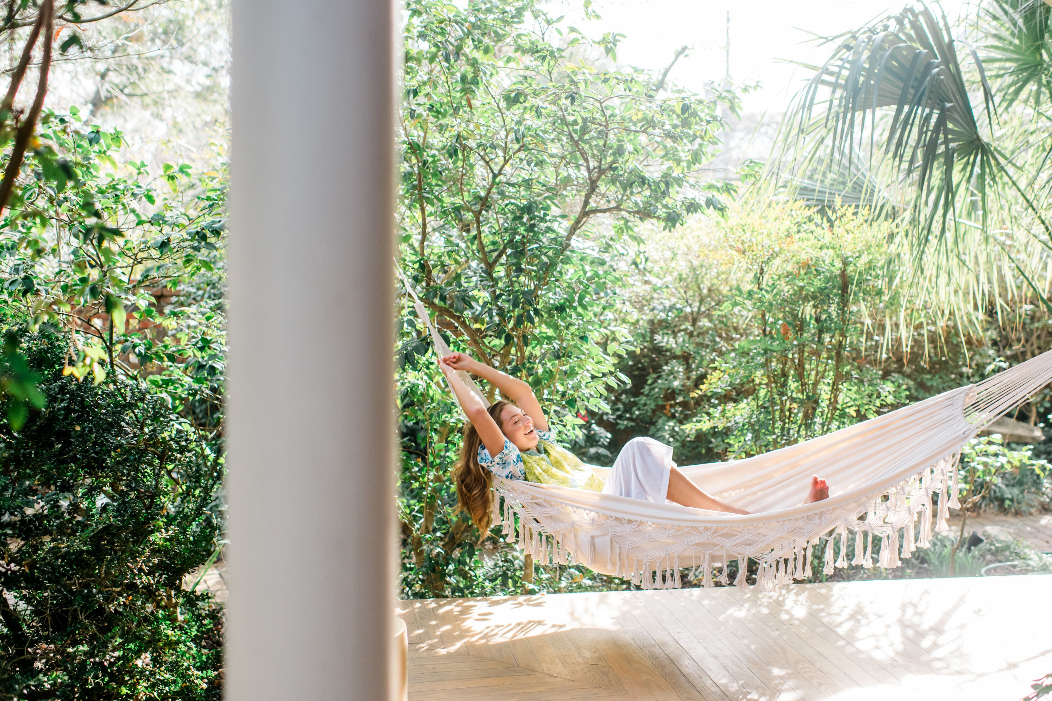 empowered woman relaxing in hammock wearing Sundara PJs