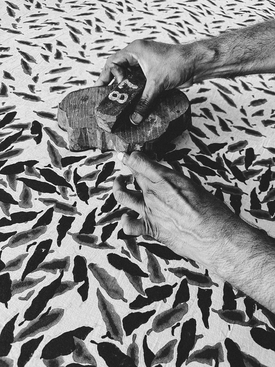 An artisan hand-block printing one of Sundara’s signature patterns using traditional techniques in our workshop in India.