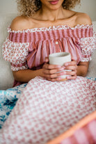 Close up of the Winnie Top by Sundara – a relaxed cotton pajama top with off-the-shoulder styling, featuring delicate hand-block prints for a laid-back, stylish look.